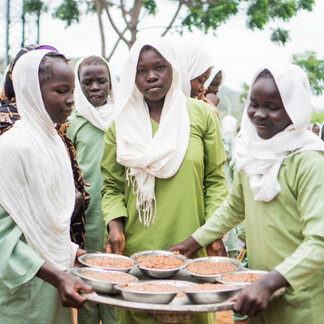 school girls are carrying their school meals
